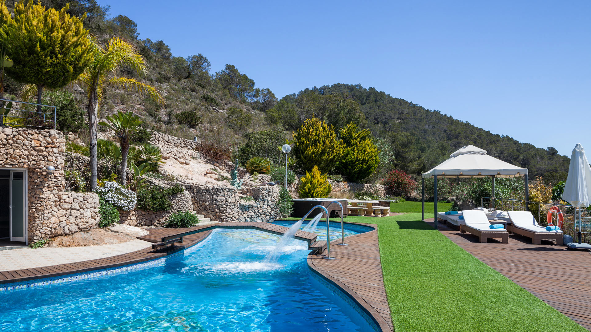 Bridge over the incredible swimming pool at luxury Villa Fountain Ibiza with water feature