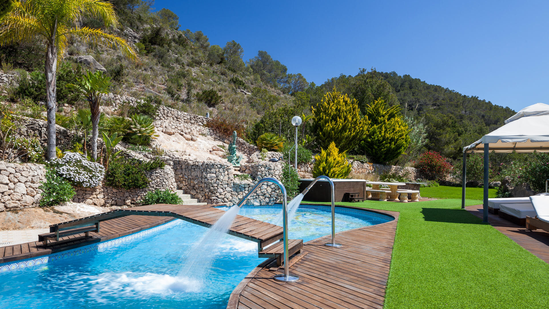 The manicured lawn of Villa Fountain Ibiza at the beautiful tree lined hill