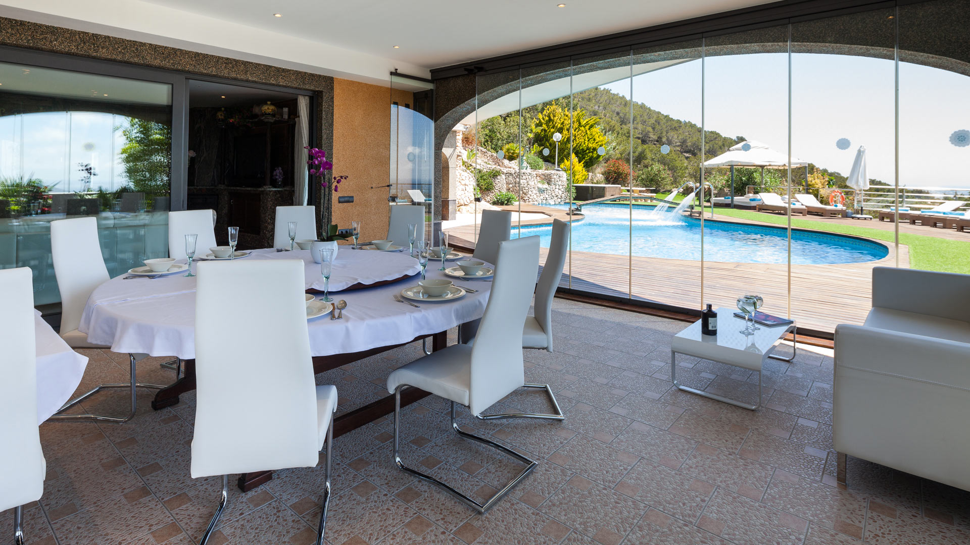 Covered dining table at Villa Fountain Ibiza looking at the pool