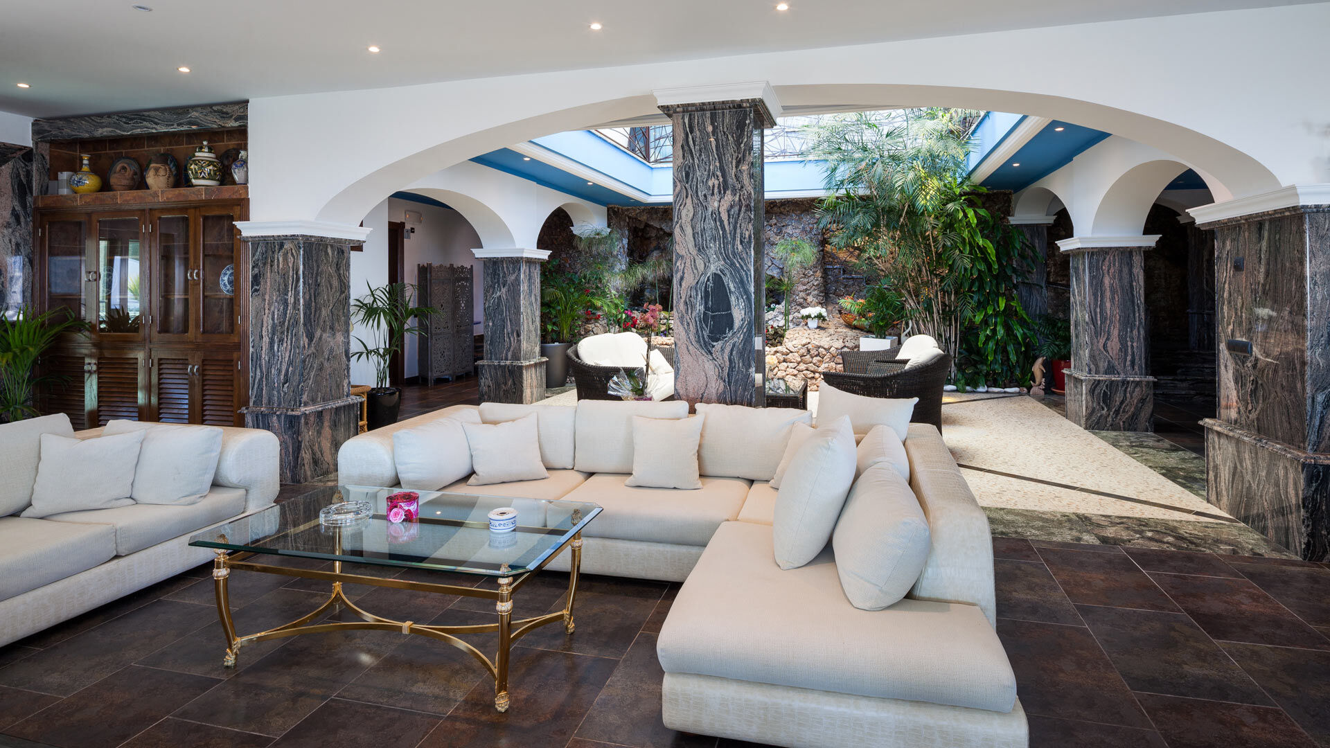 Beautiful living room with large sofas and natural sunlight at Villa Fountain Ibiza
