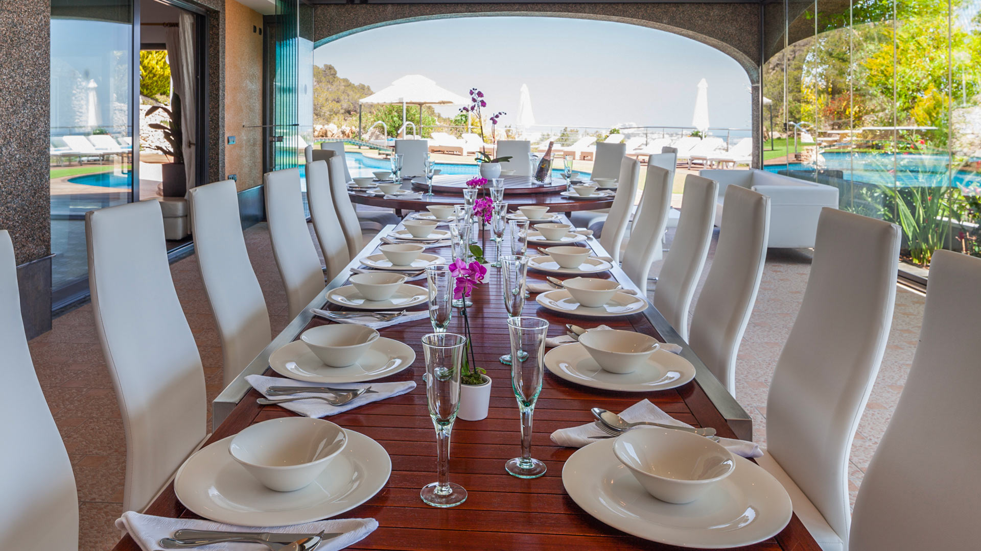 The indoor/outdoor dining area at Villa Fountain Ibiza with pool views