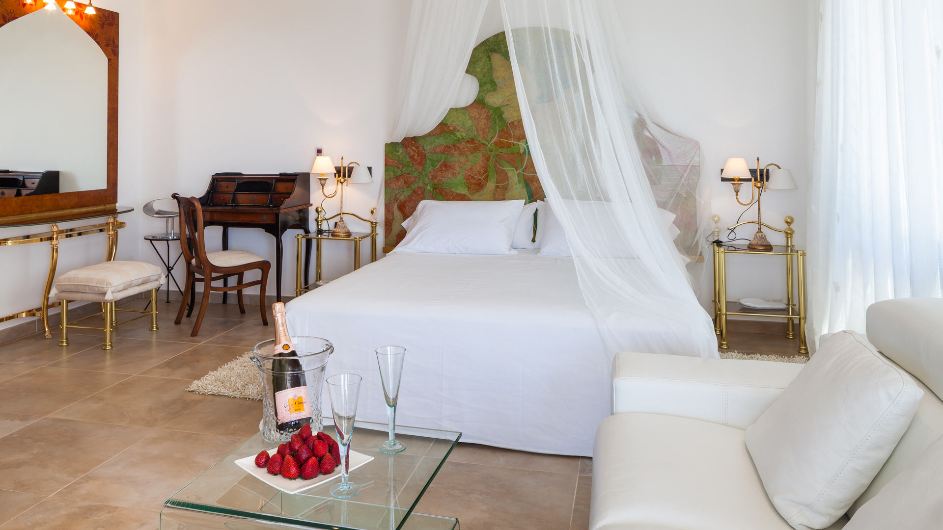 One of the bedrooms at Villa Fountain Ibiza with a canopy and bottle of champagne