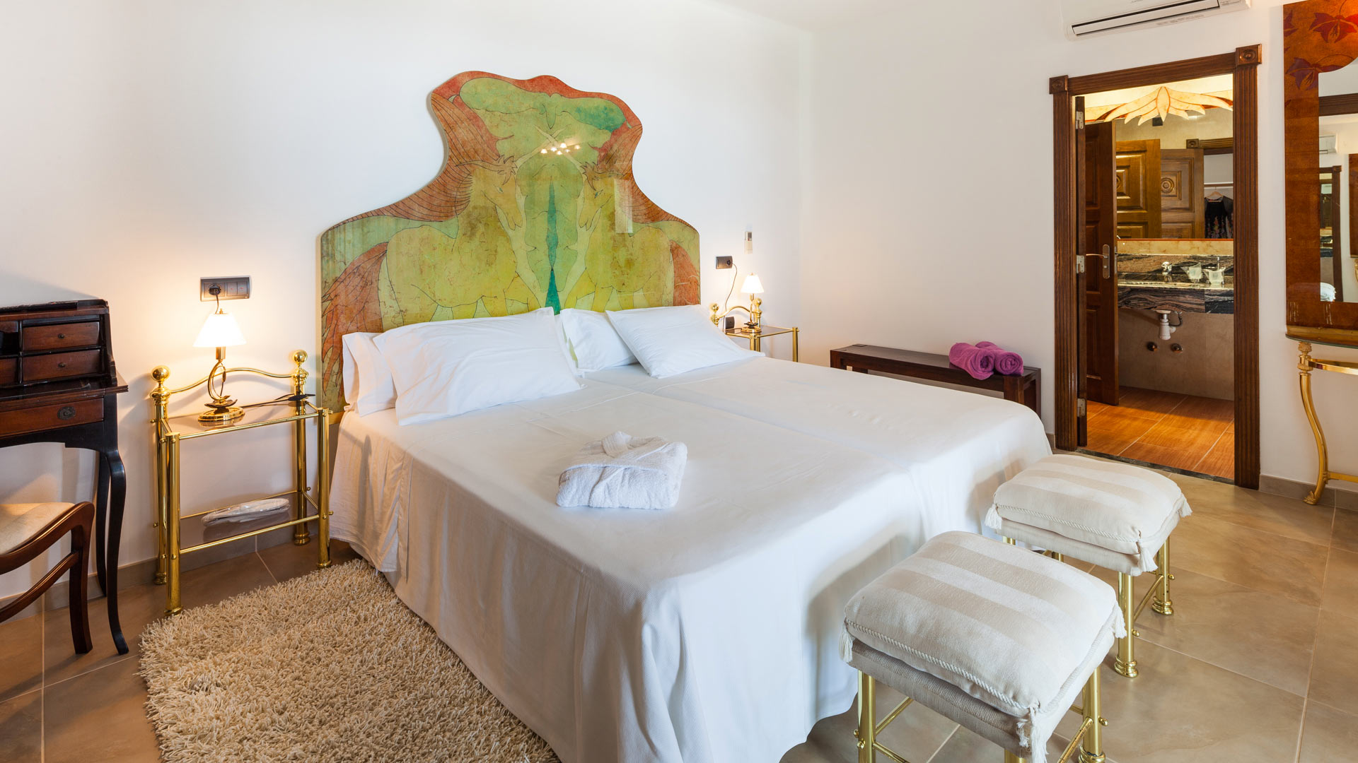 One of the large bedrooms in Villa Fountain Ibiza with beautiful headboard