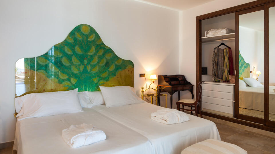 The white linens in one of the bedrooms at Villa Fountain Ibiza with storage