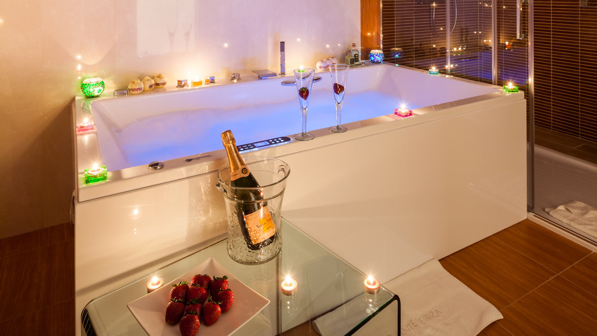 Bathroom at Villa Fountain Ibiza with a jacuzzi style bathtub drawn to enjoy