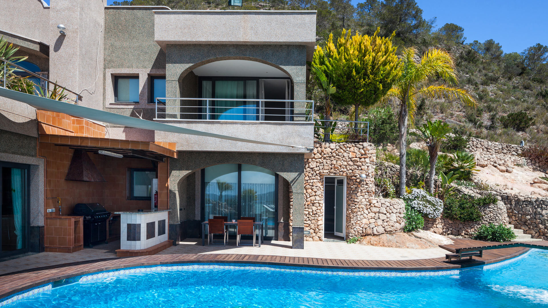 Back exterior view of Villa Fountain Ibiza and the large swimming pool