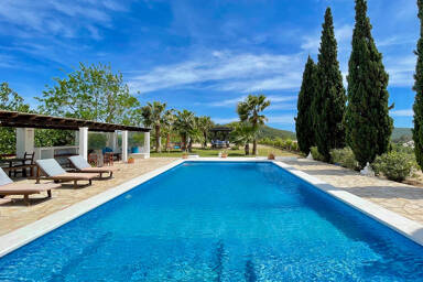 Long pool with beautifully well appointed trees at Villa Torre Pau in Ibiza