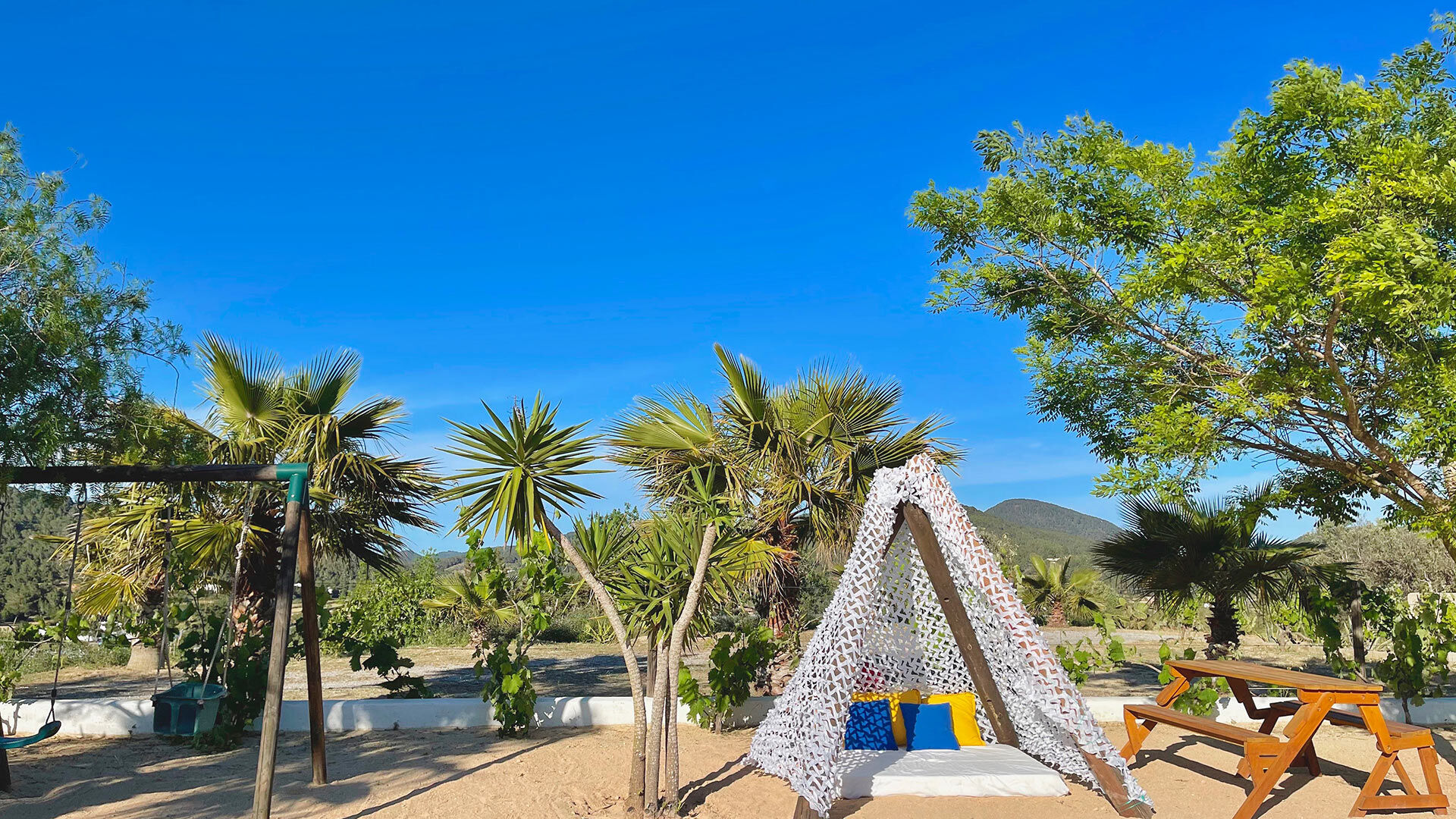 Small tepee and swing set in the garden of Villa Torre Pau in Ibiza