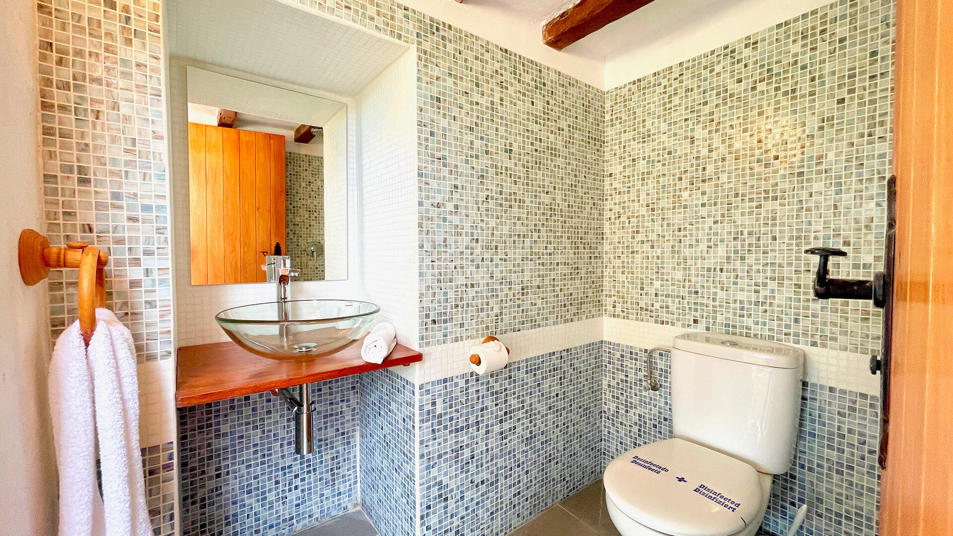 Mixed tile bathroom with fresh linens in Villa Torre Pau in Ibiza