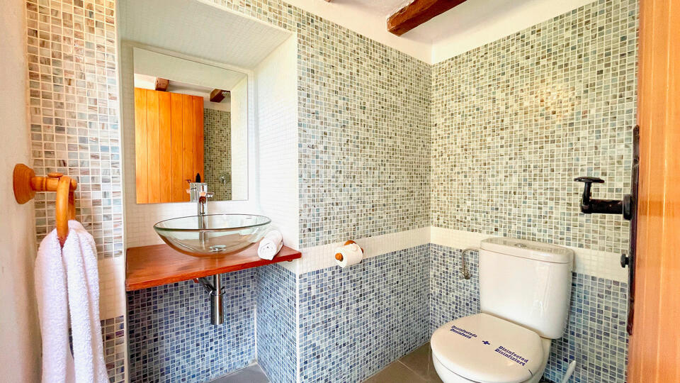 Mixed tile bathroom with fresh linens in Villa Torre Pau in Ibiza