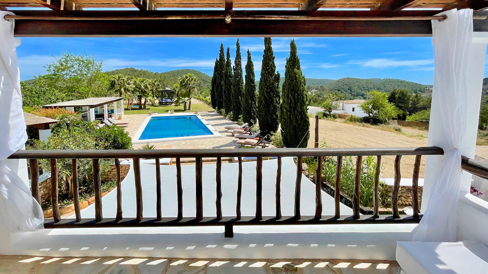 Balcony view overlooking the pool and the land at Villa Torre Pau