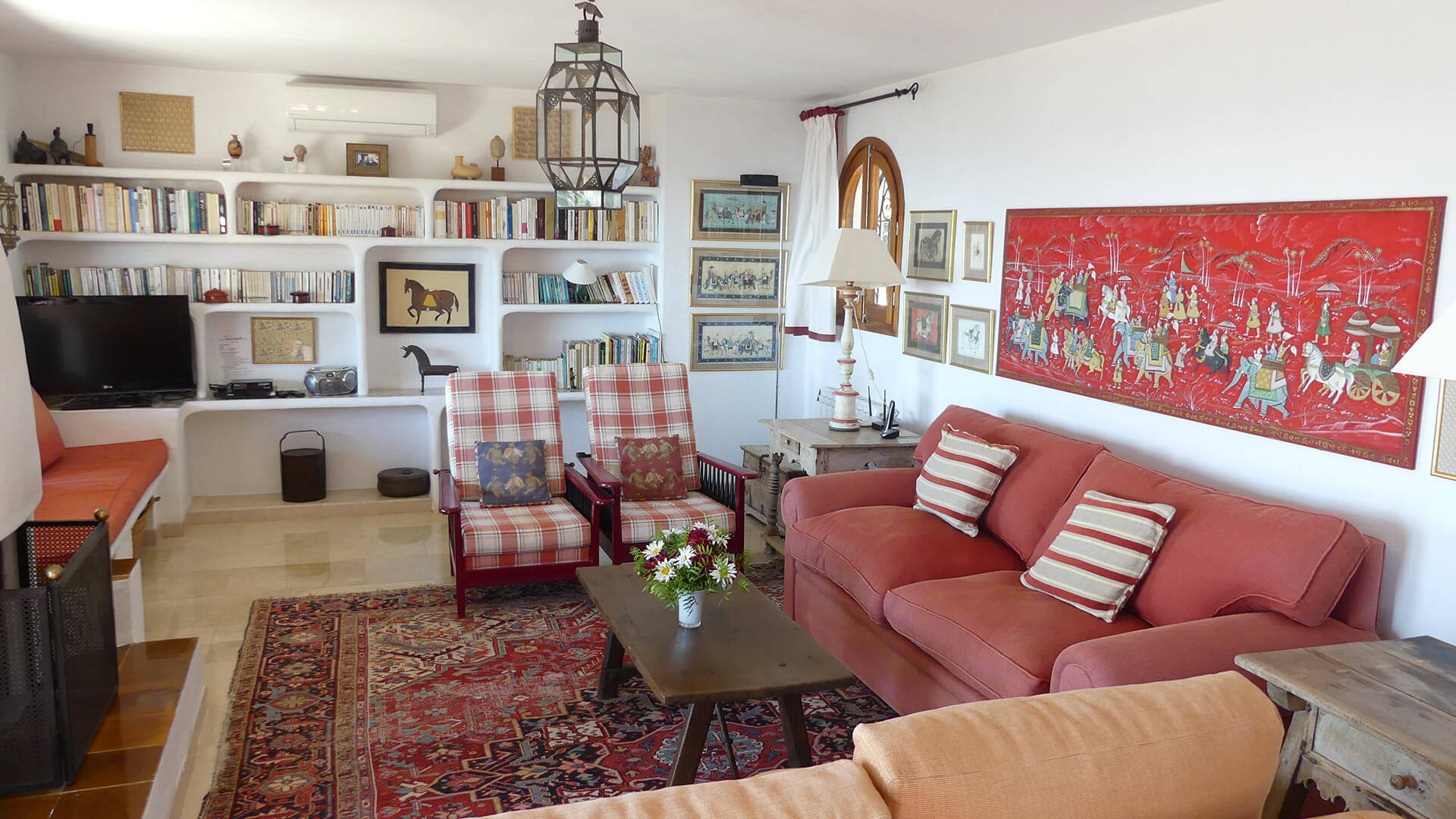 Living space at Villa Trillo in Ibiza with red accents throughout