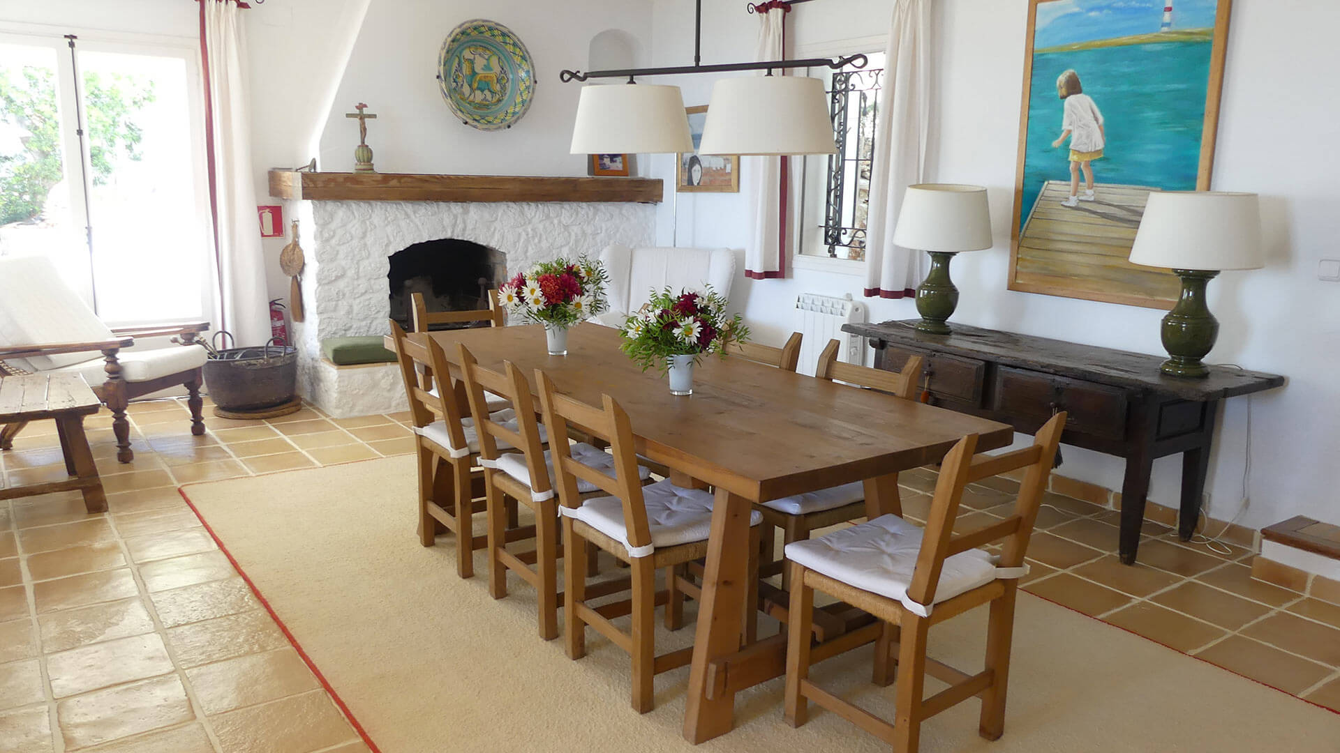 The dining space at Villa Trillo in Ibiza with a beautiful fireplace feature
