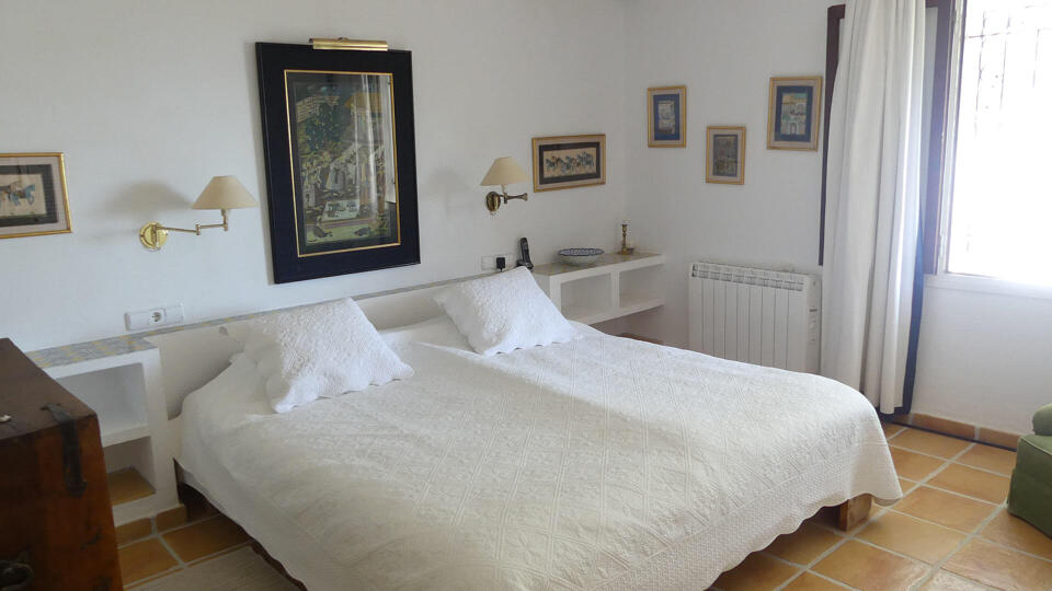One of the larger bedrooms in Villa Trillo in Ibiza with plenty of classic Ibizan features