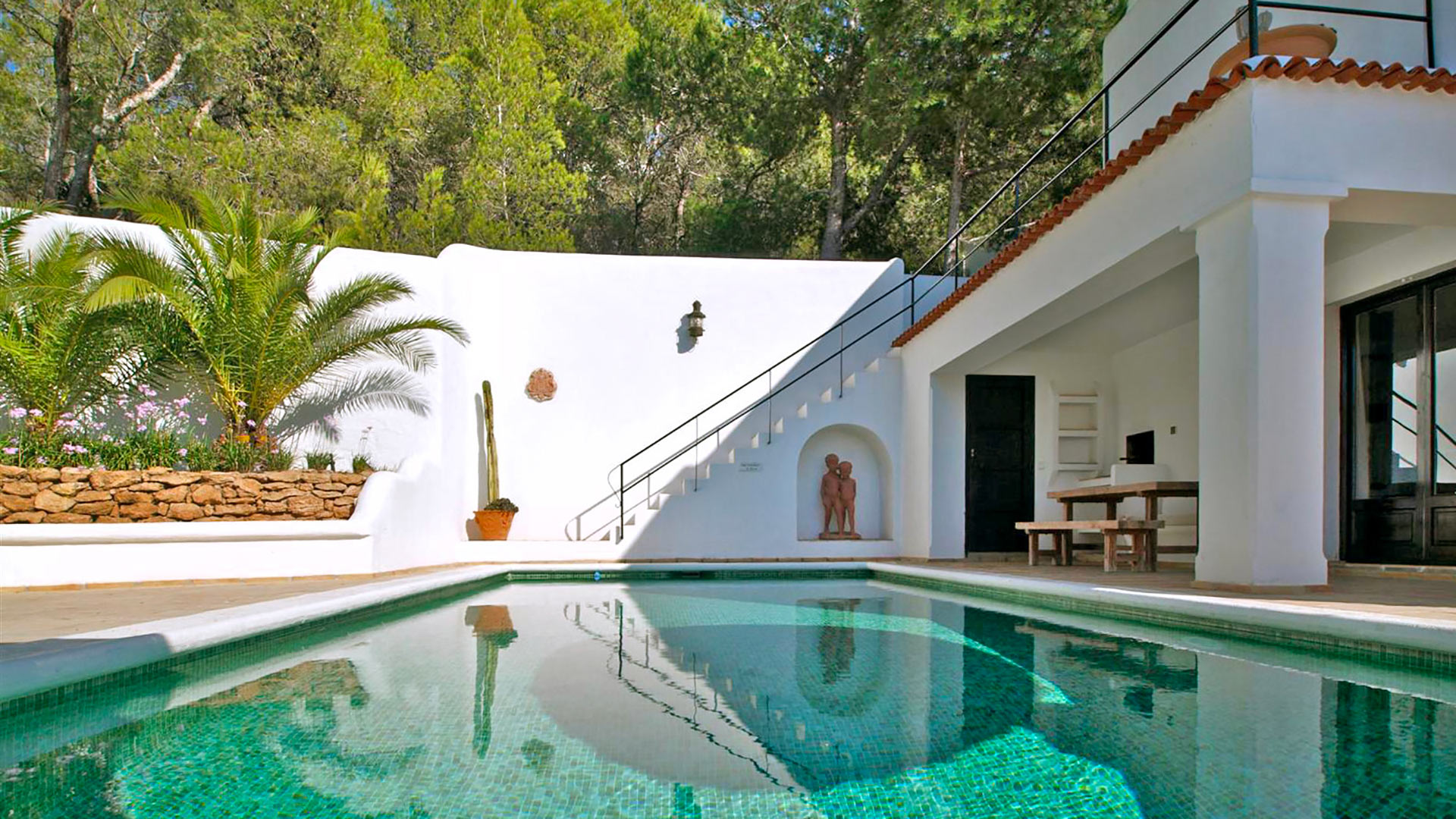 Villa Trillo's swimming pool in Ibiza with a beautiful green hue ideal for morning swims