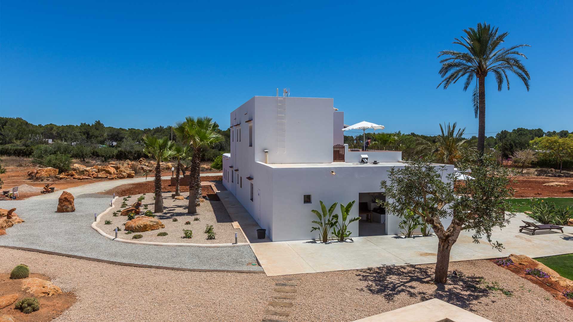 Exterior side view of Villa Es Canar in Ibiza and the desert style surroundings
