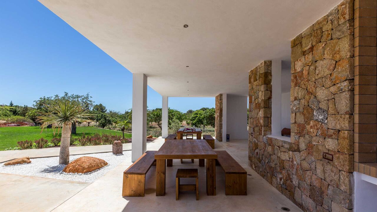 Shaded long dining bench at Villa Es Canar in Ibiza