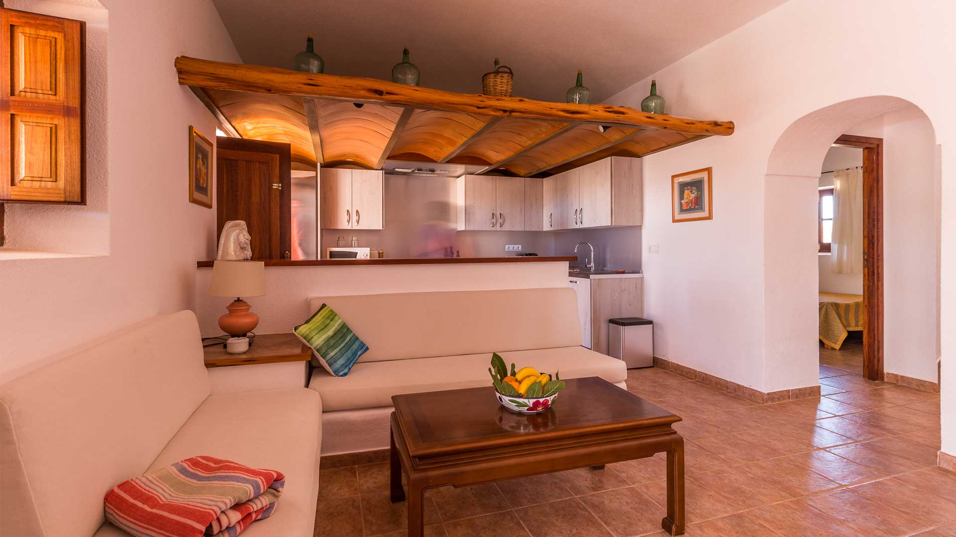Kitchen with small living area in front to unwind at Villa Es Canar in Ibiza