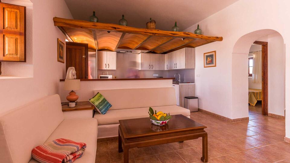 Kitchen with small living area in front to unwind at Villa Es Canar in Ibiza