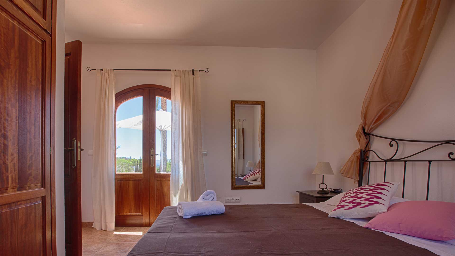 Large bedroom at Villa Es Canar in Ibiza with patio doors