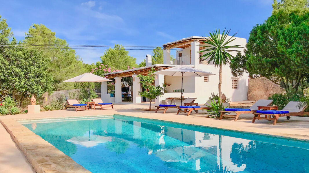 Villa Garroba and the light blue swimming pool in luxury Ibiza villa rental