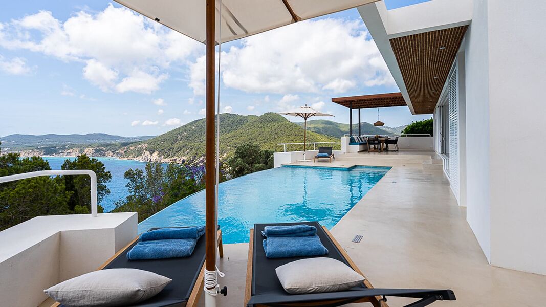 Sunloungers next to the infinity pool at Villa Orizonia in Ibiza