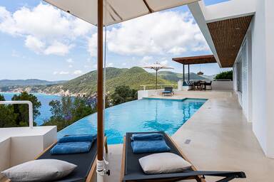 Sunloungers next to the infinity pool at Villa Orizonia in Ibiza