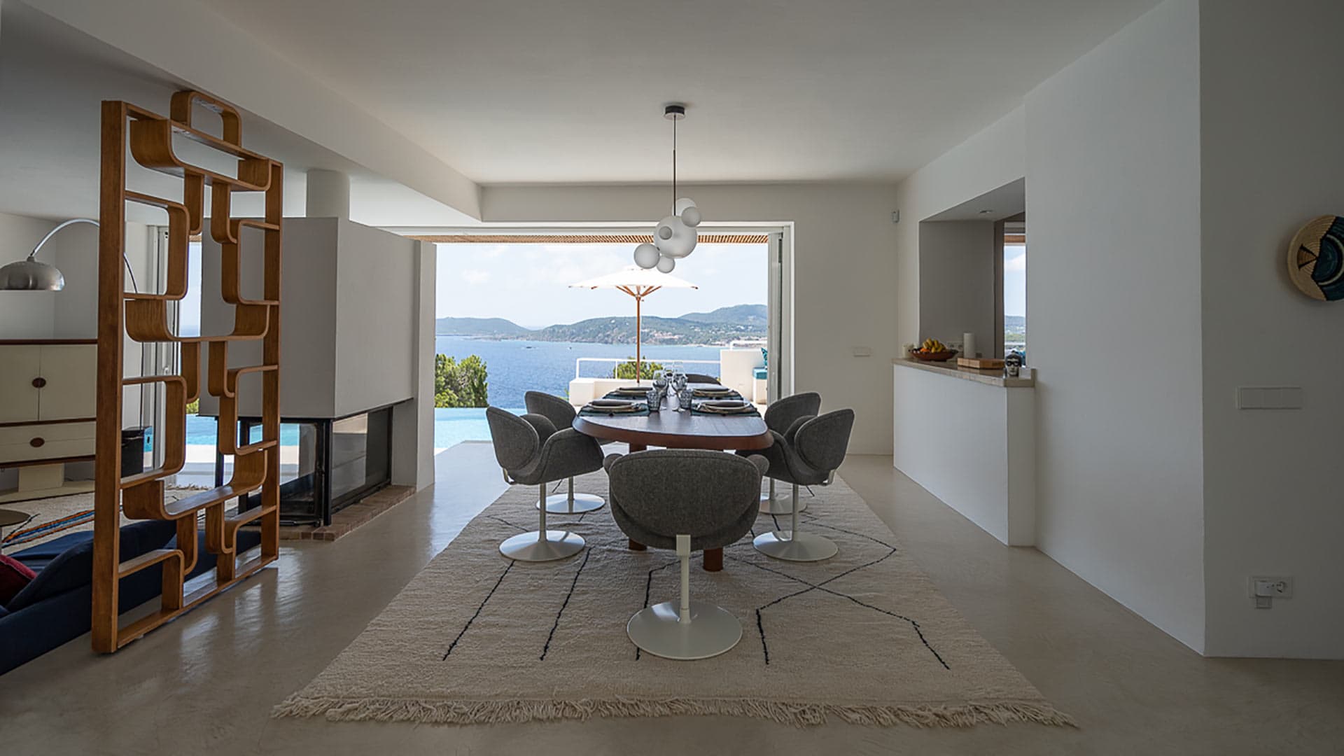 Dining room at Villa Orizonia in Ibiza with large patio doors looking at the pool and Sea