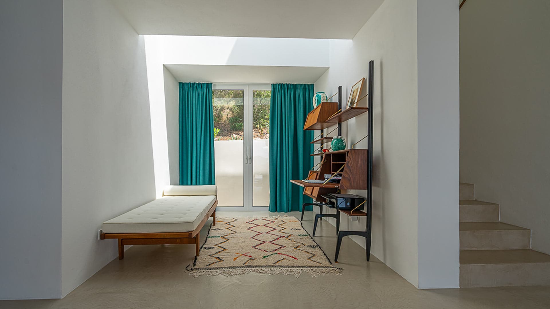 A single bedroom in Villa Orizonia in Ibiza with patio doors to the outside and large amounts of space