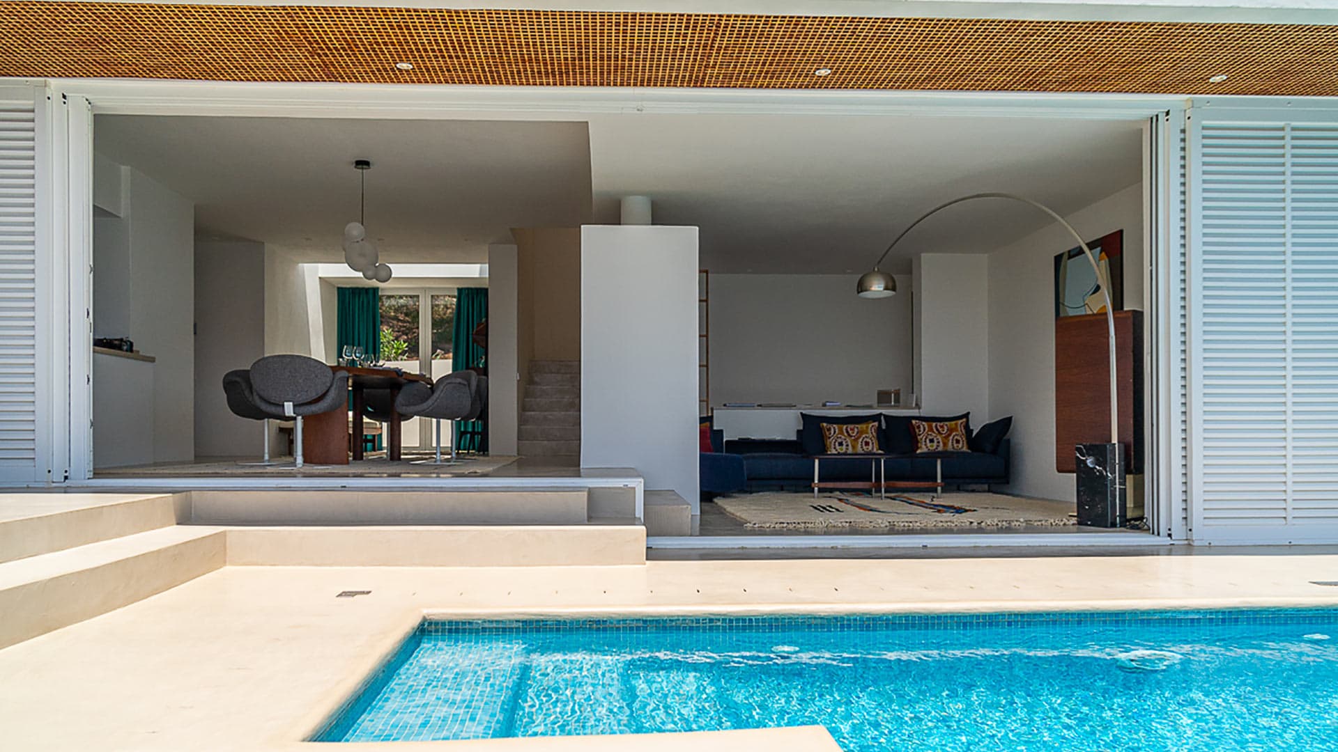 Opened sliding french doors at Villa Orizonia in Ibiza with the pool view