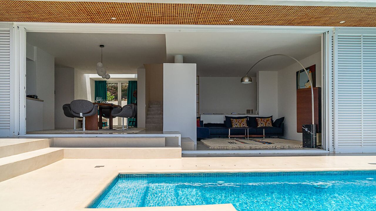 Opened sliding french doors at Villa Orizonia in Ibiza with the pool view