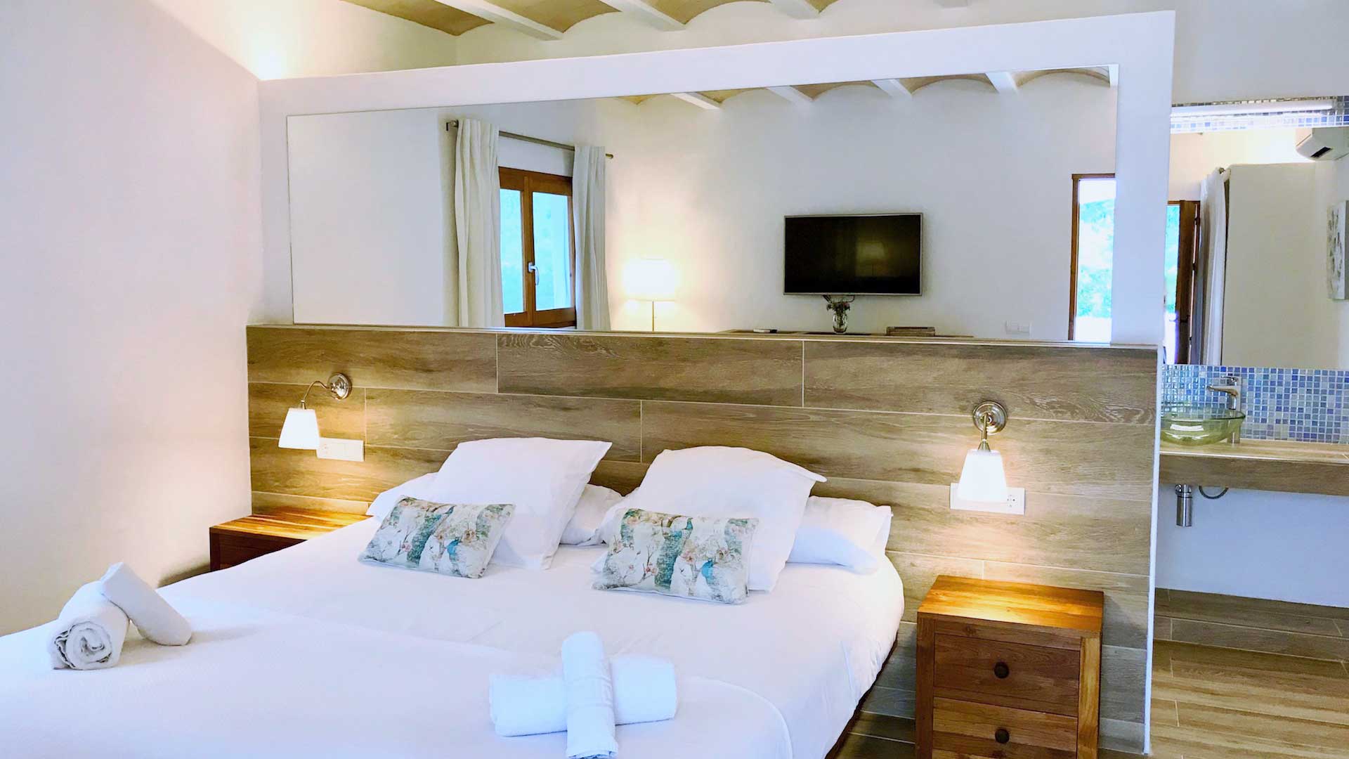 Large bedroom in Villa Payesa in Ibiza with wooden accents throughtout