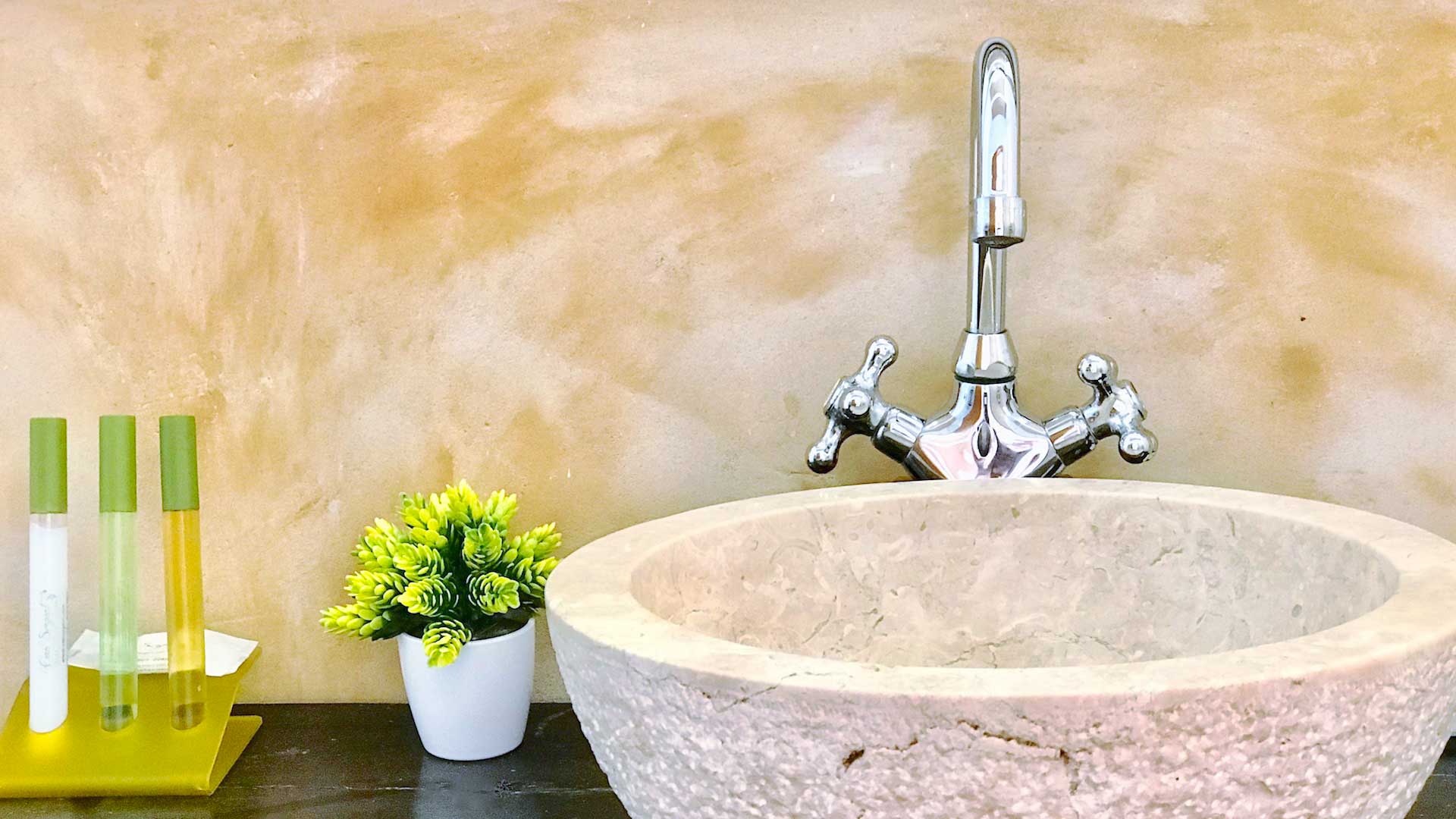 One of the large sinks in Villa Payesa's bathrooms with small toiletries to the side