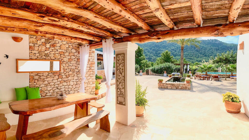 Pergola with a bench underneath at Villa Payesa perfect for alfresco meals