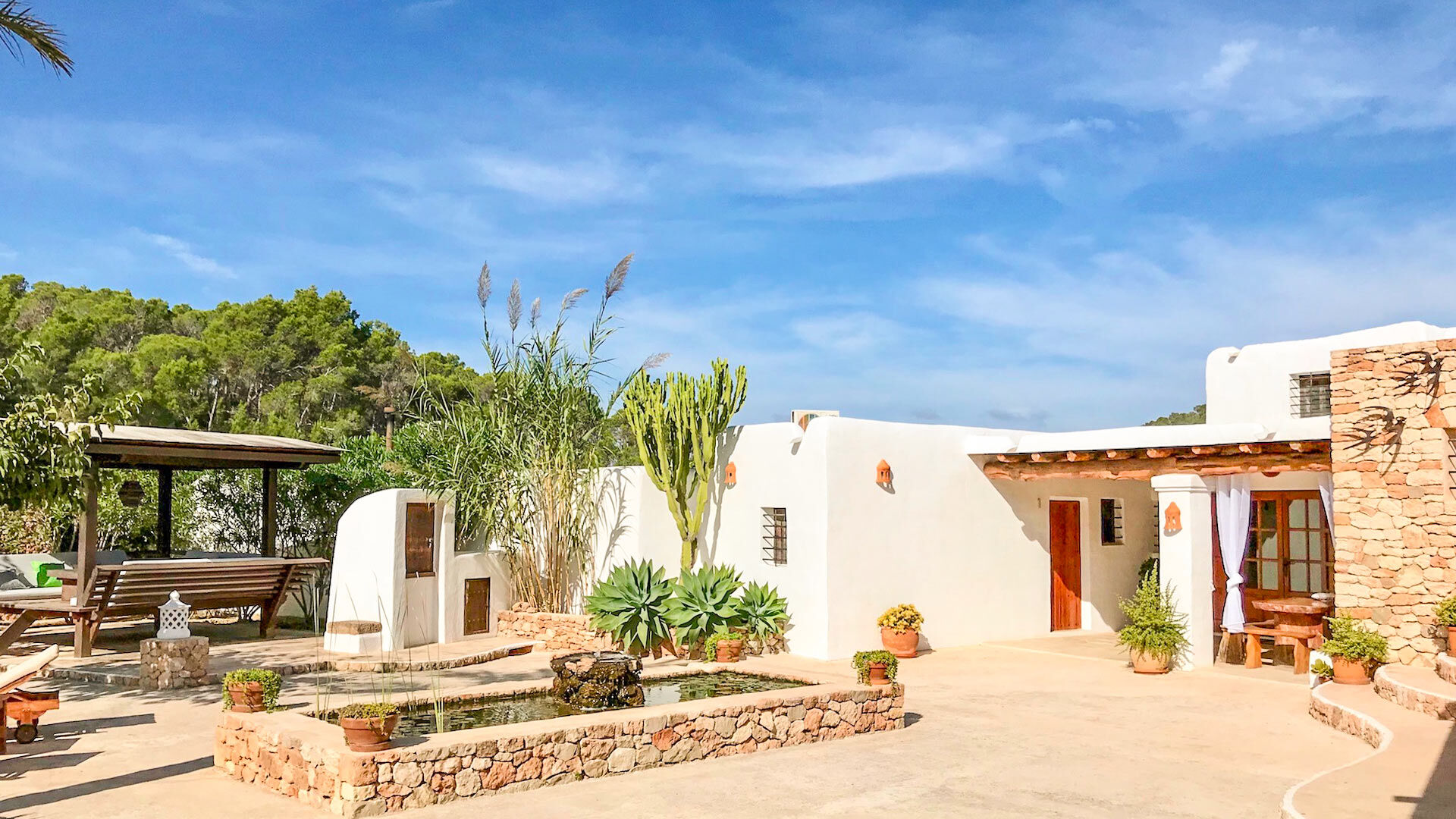 Exterior of Villa Payesa in Ibiza with a small water feature
