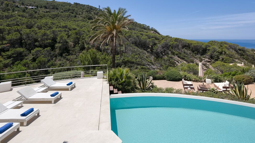 Gorgeous view of the infinity pool at Villa Pepallania overlooking the beautiful Mediterranean Sea and Ibiza hillside