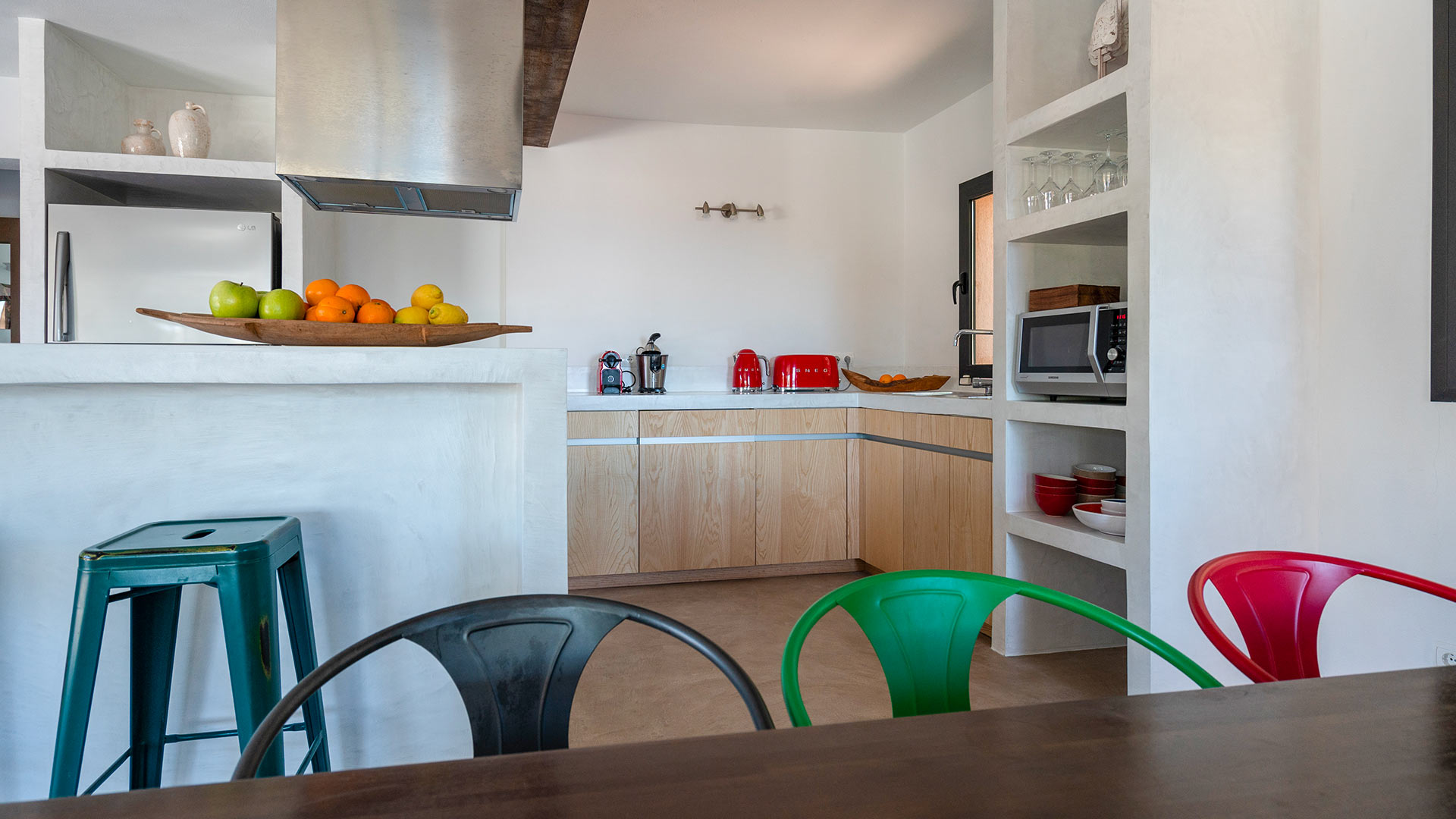 Dining area with colour chairs at Villa Tiramar in Ibiza