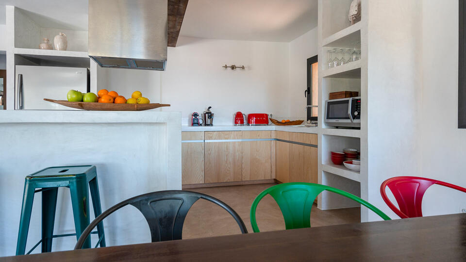 Dining area with colour chairs at Villa Tiramar in Ibiza