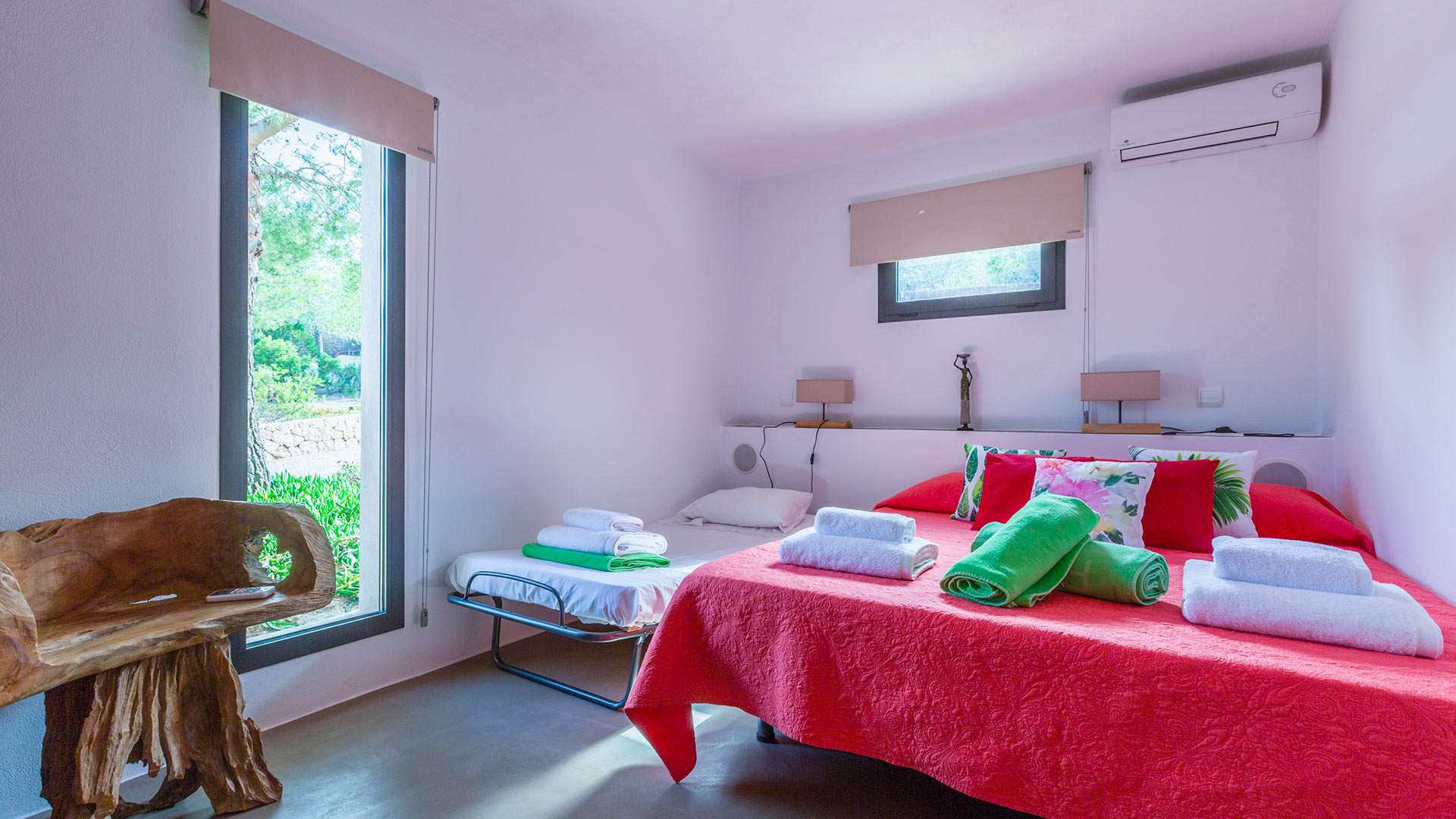 Large bedroom at Villa Tiramar in Ibiza with plenty of natural light from the large open windows