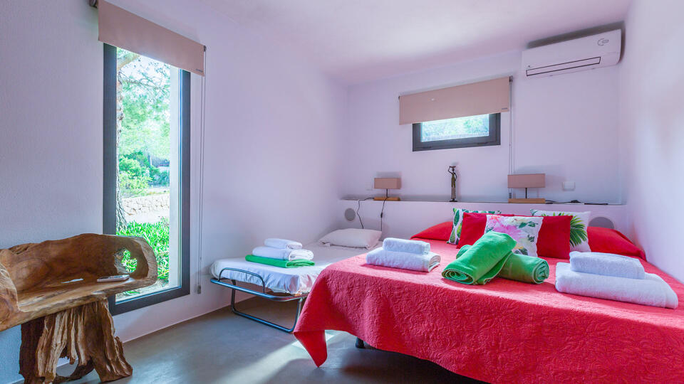 Large bedroom at Villa Tiramar in Ibiza with plenty of natural light from the large open windows