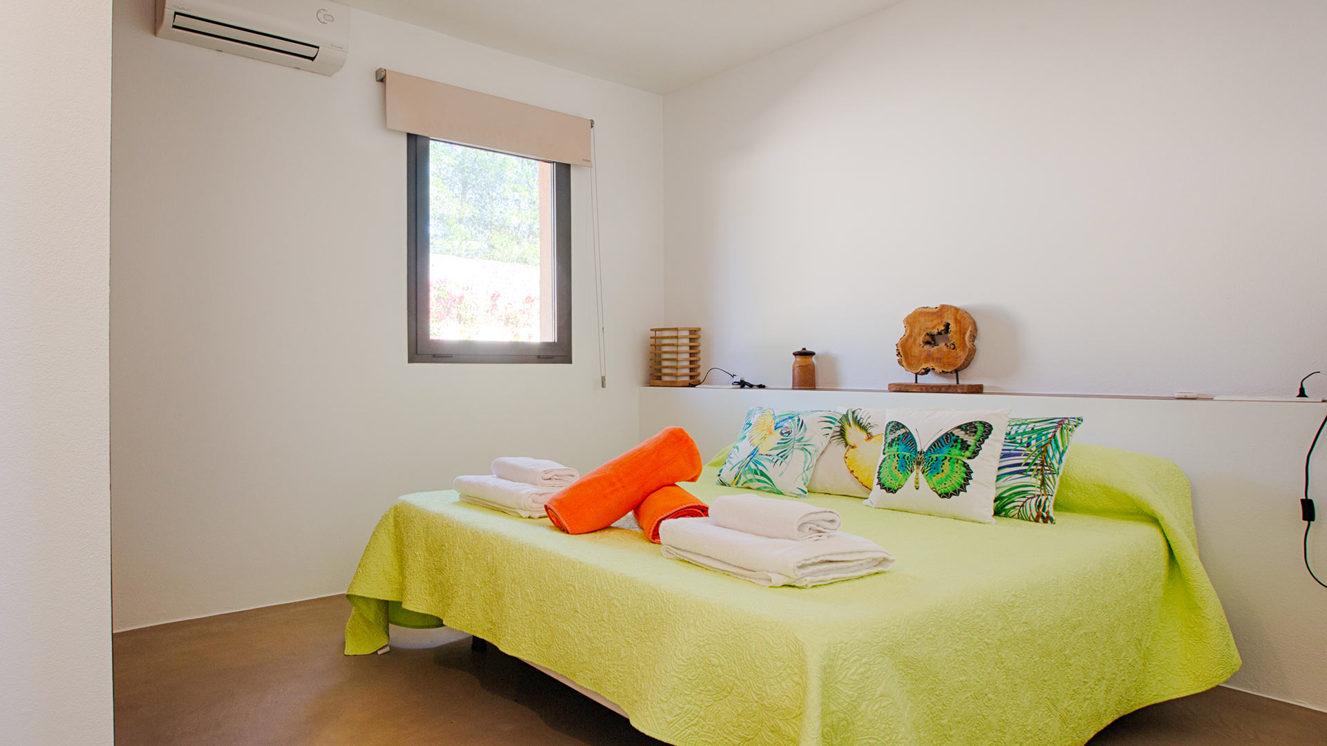 Bright pop of colours in the bedroom at Villa Tiramar which has a lime green duvet sheet