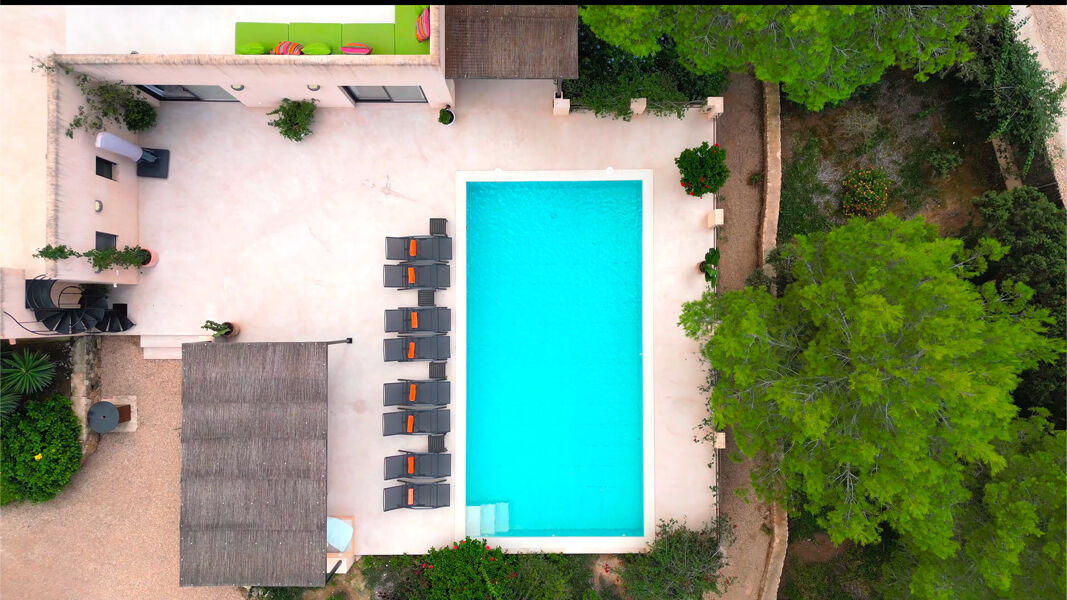 Aerial view of the beautifully light blue swimming pool at Villa Tiramar in Ibiza