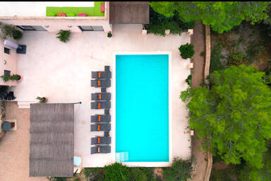 Aerial view of the beautifully light blue swimming pool at Villa Tiramar in Ibiza