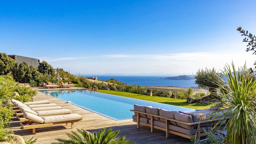 Pool side at Villa Vannina with lush gardens and comfy sofas, overlooking the Tyrrhenian Sea