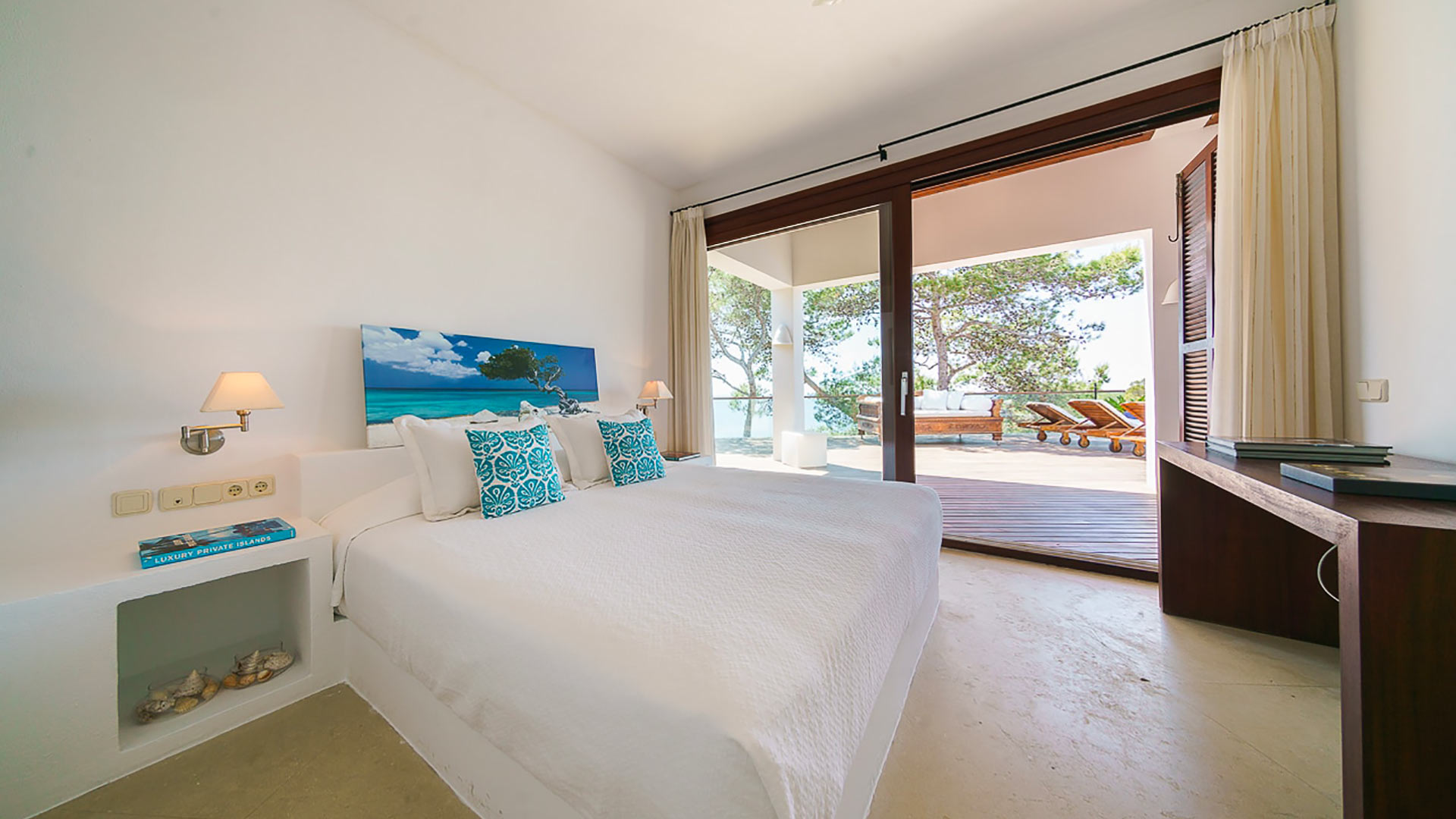 Bedroom with floor to ceiling windows with outdoor access in Voramar, a luxury Ibizan villa