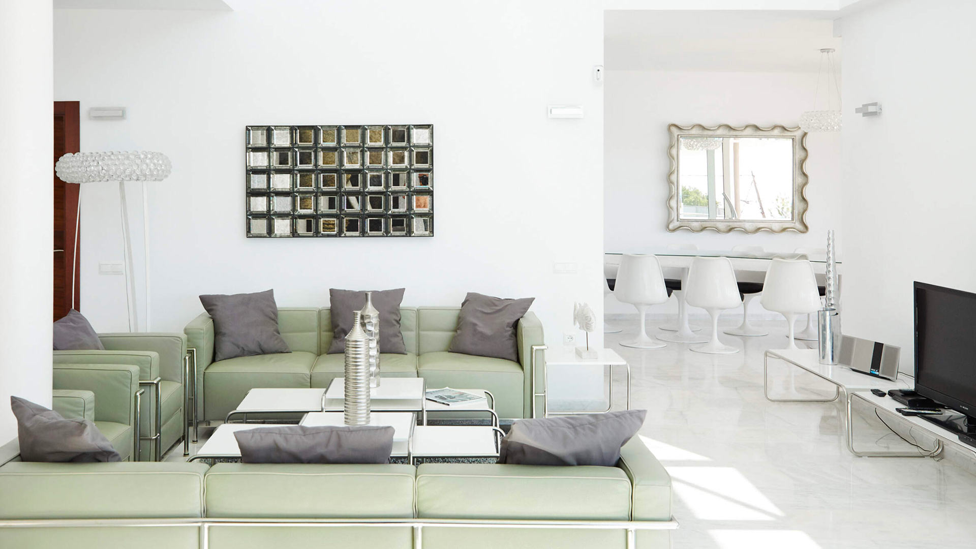 Large living area at Villa White Beach in Ibiza with large green sofa set up ideal for planning day