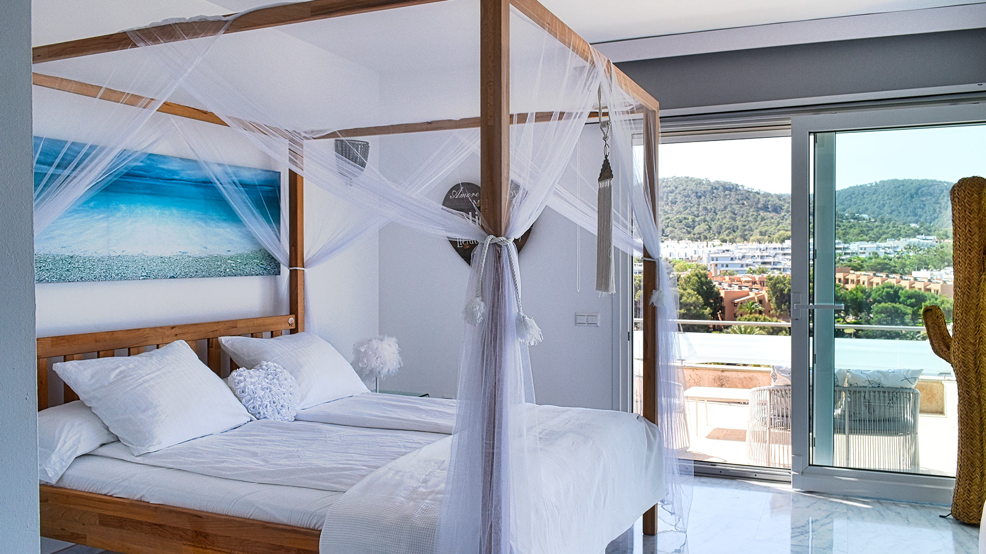 Patio doors and perfect Ibiza views from a bedroom at Villa White Beach