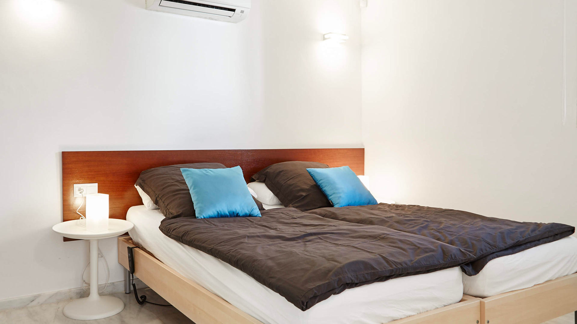 One of the bedrooms at Villa White Beach in Ibiza, with two singles available as a double