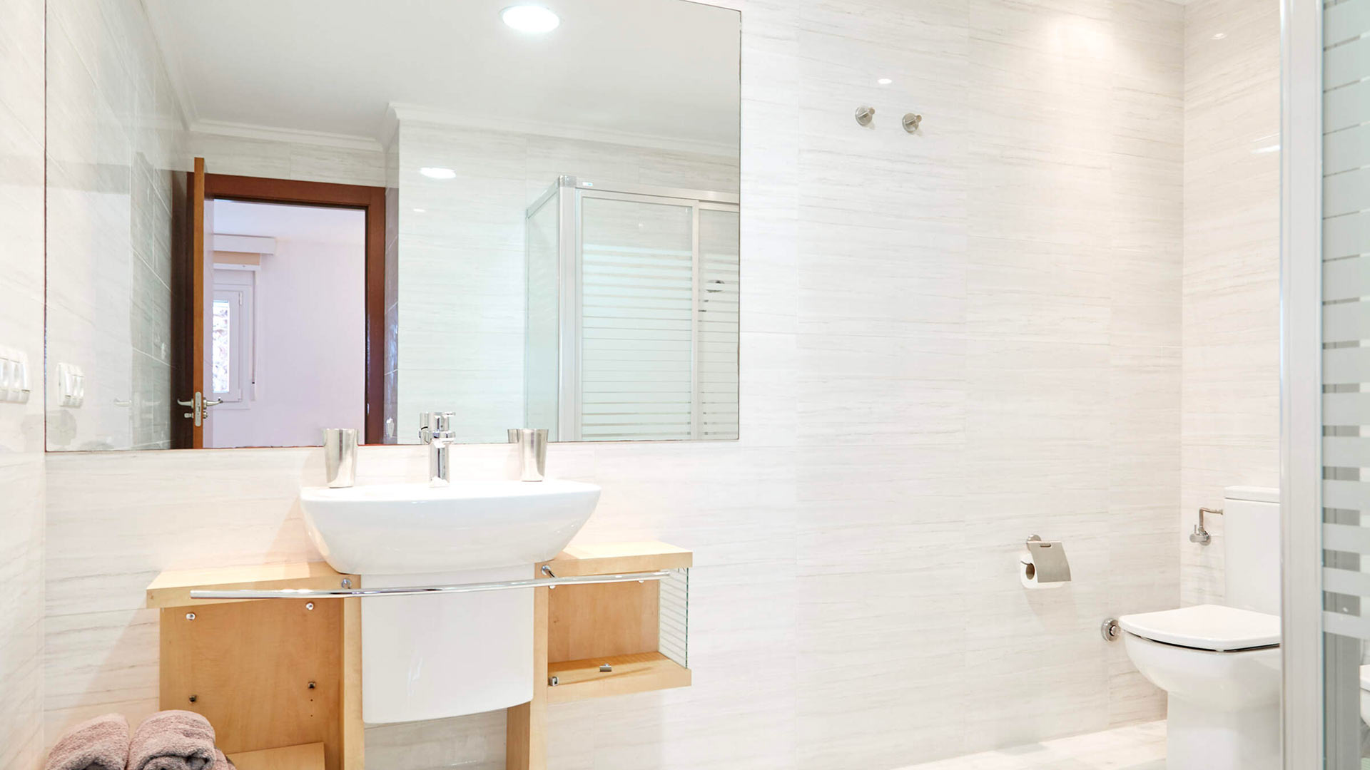Large tiled bathroom at Villa White Beach in Ibiza with a huge mirror