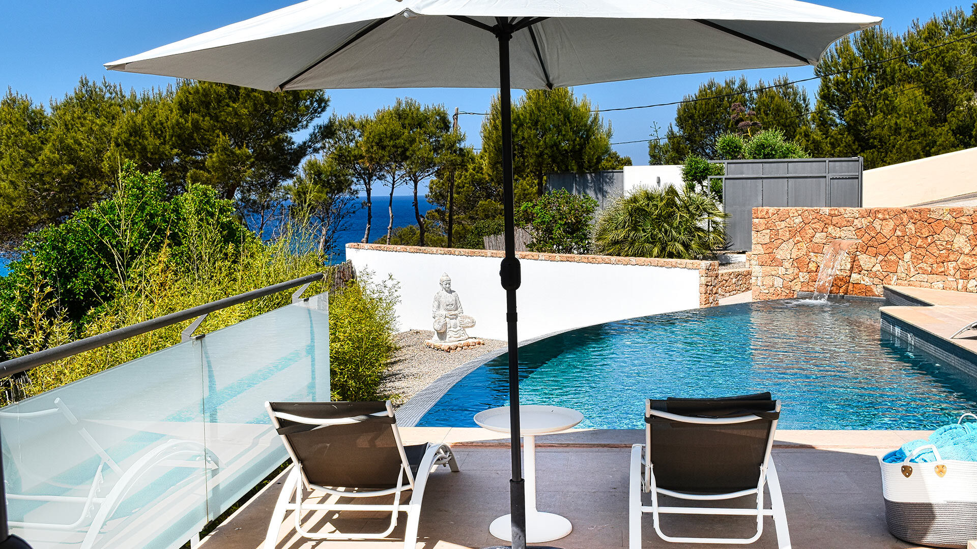 Shaded sunloungers next to the pool at Villa White Beach in Ibiza